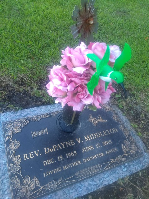 gravestone with a hummingbird decoration