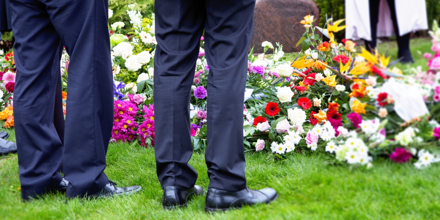 Standing next to a grave